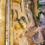 Aerial view of a mining site with a drone surveying the landscape for data collection and analysis.